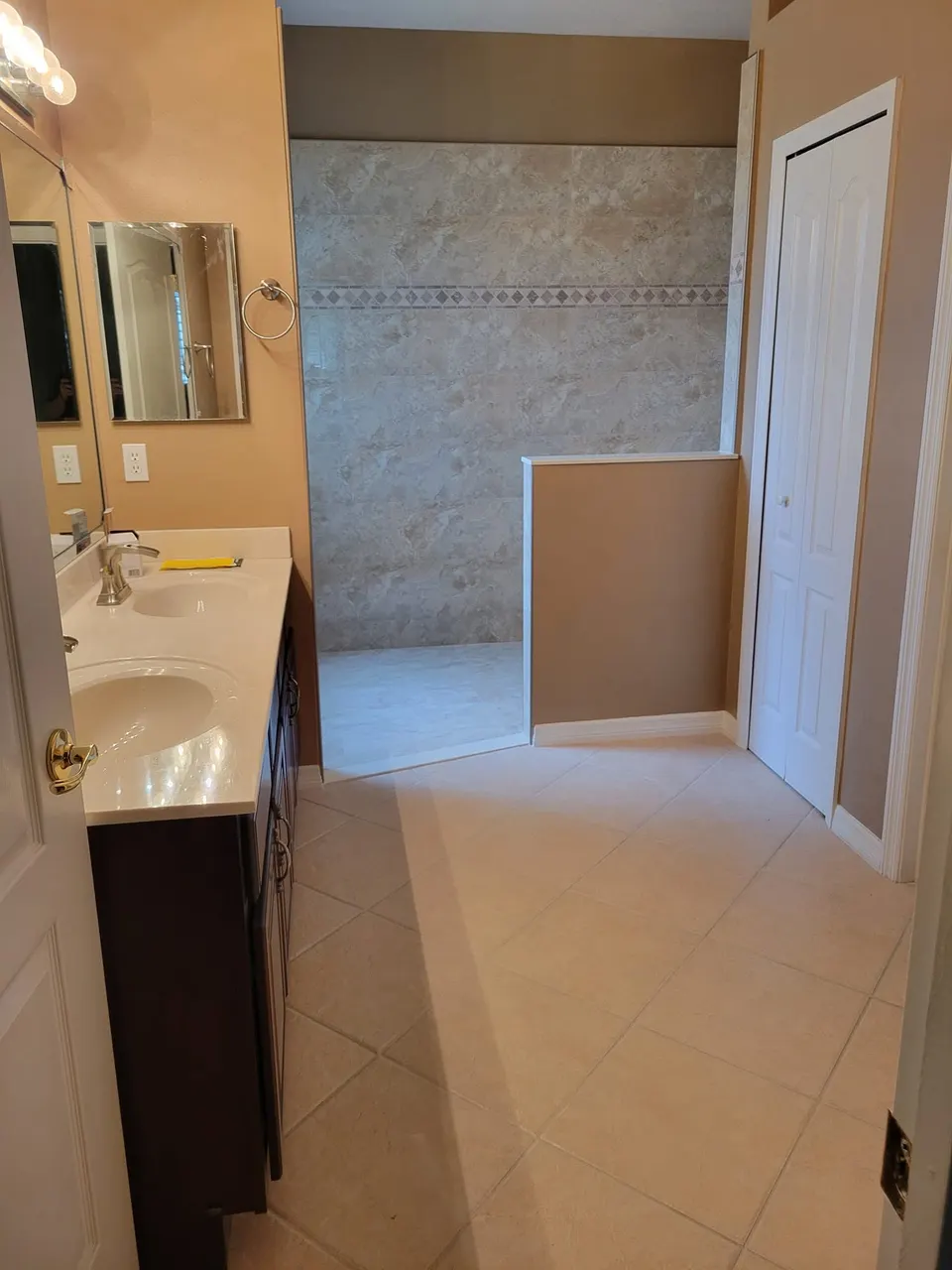 Walk-in shower conversion with marble-look tile